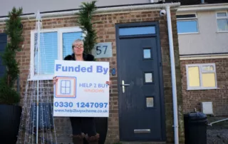 Grant customer infront of house with new casement windows