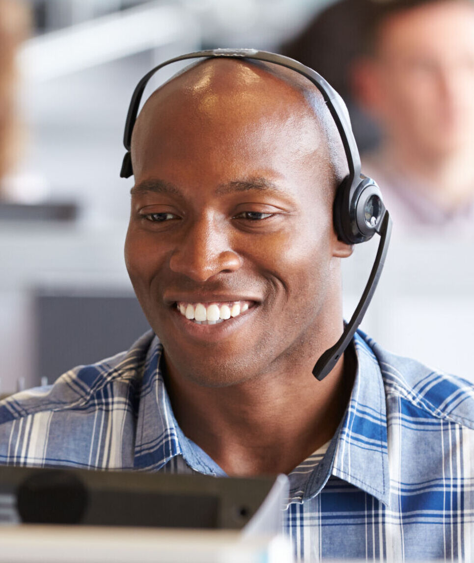 African,American,Man,Working,At,A,Computer,In,A,Call man on phone in the call centre